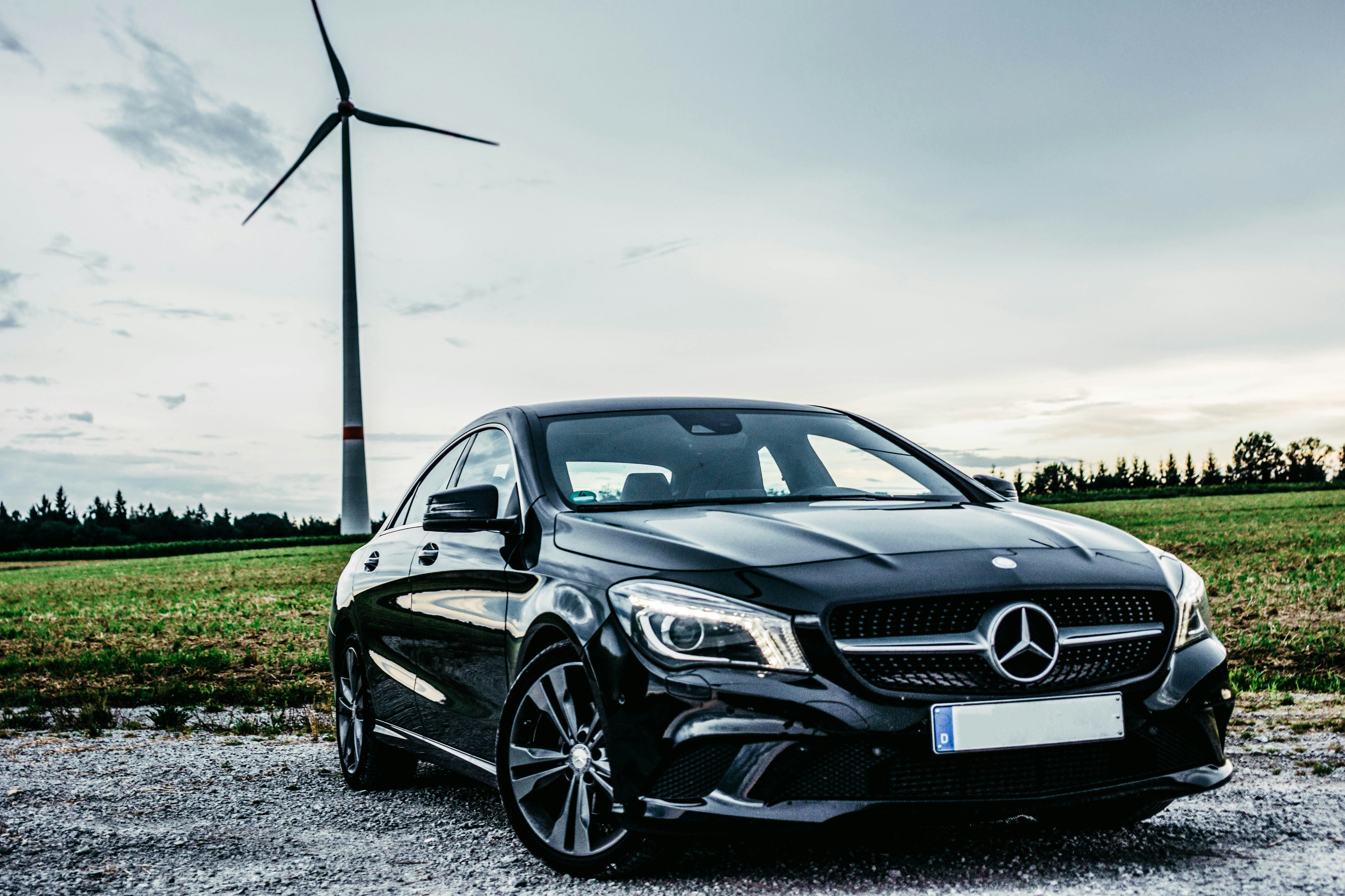 black Mercedes-Benz vehicle park near windmill